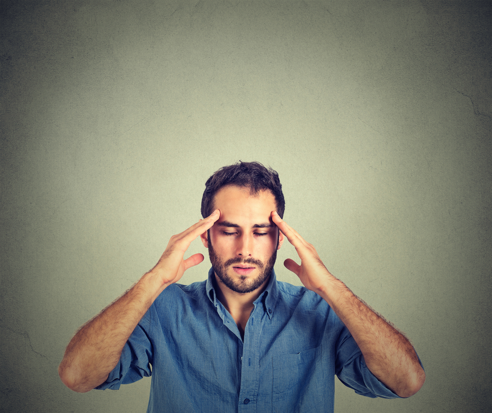 man thinking very intensely concentrating isolated on gray wall background